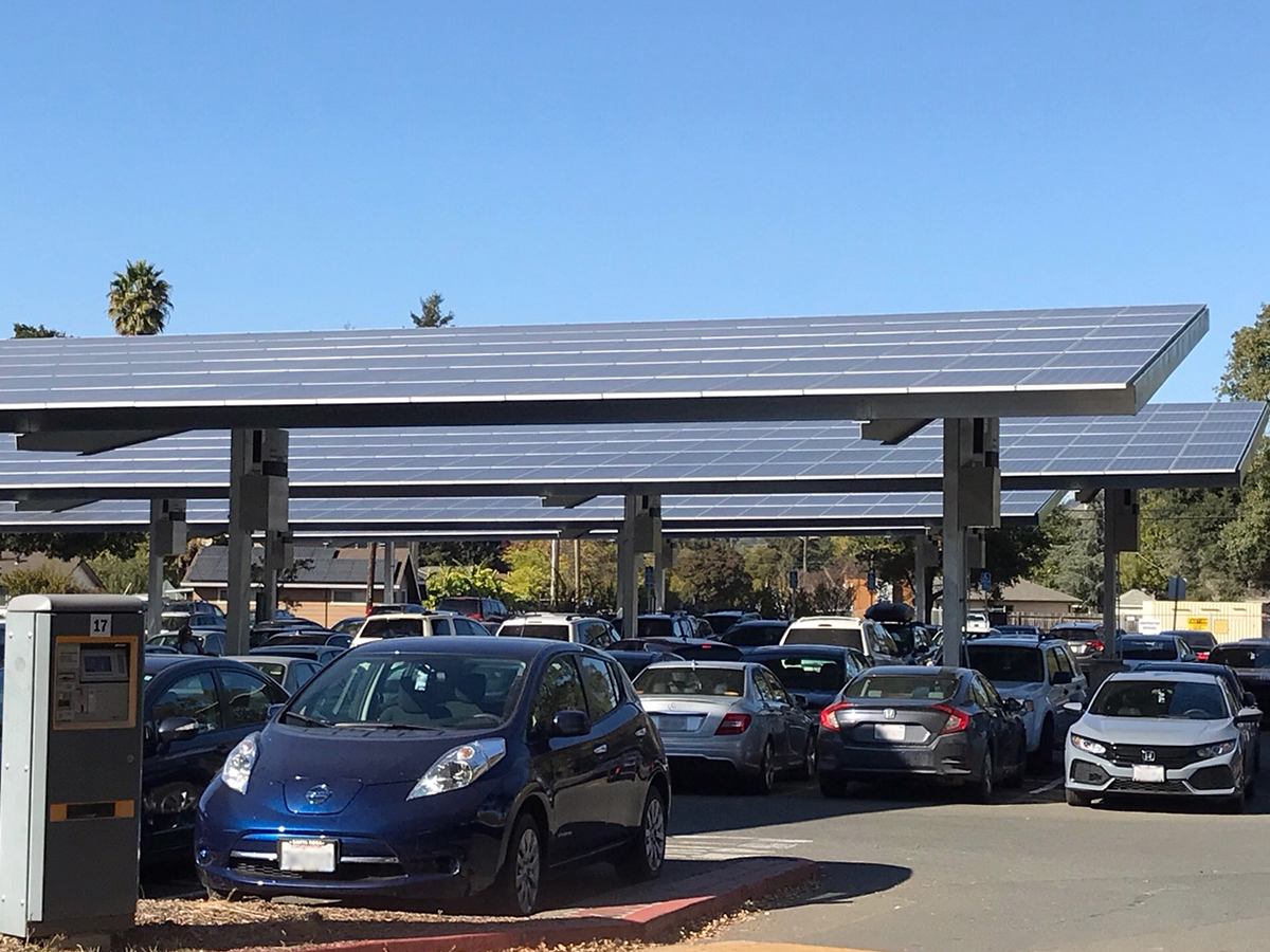 Parking lot with solar panels providing shade.