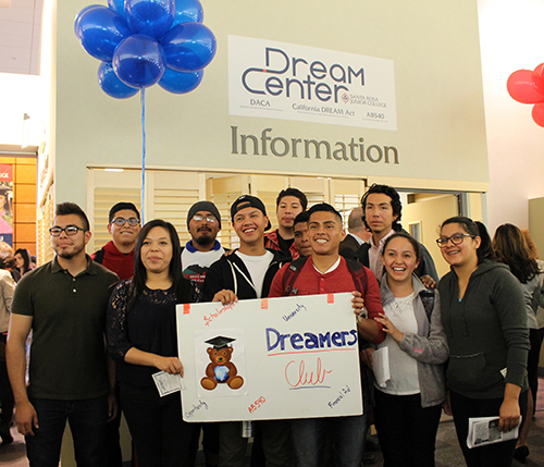 Smiling crowd in front of office, ballons above