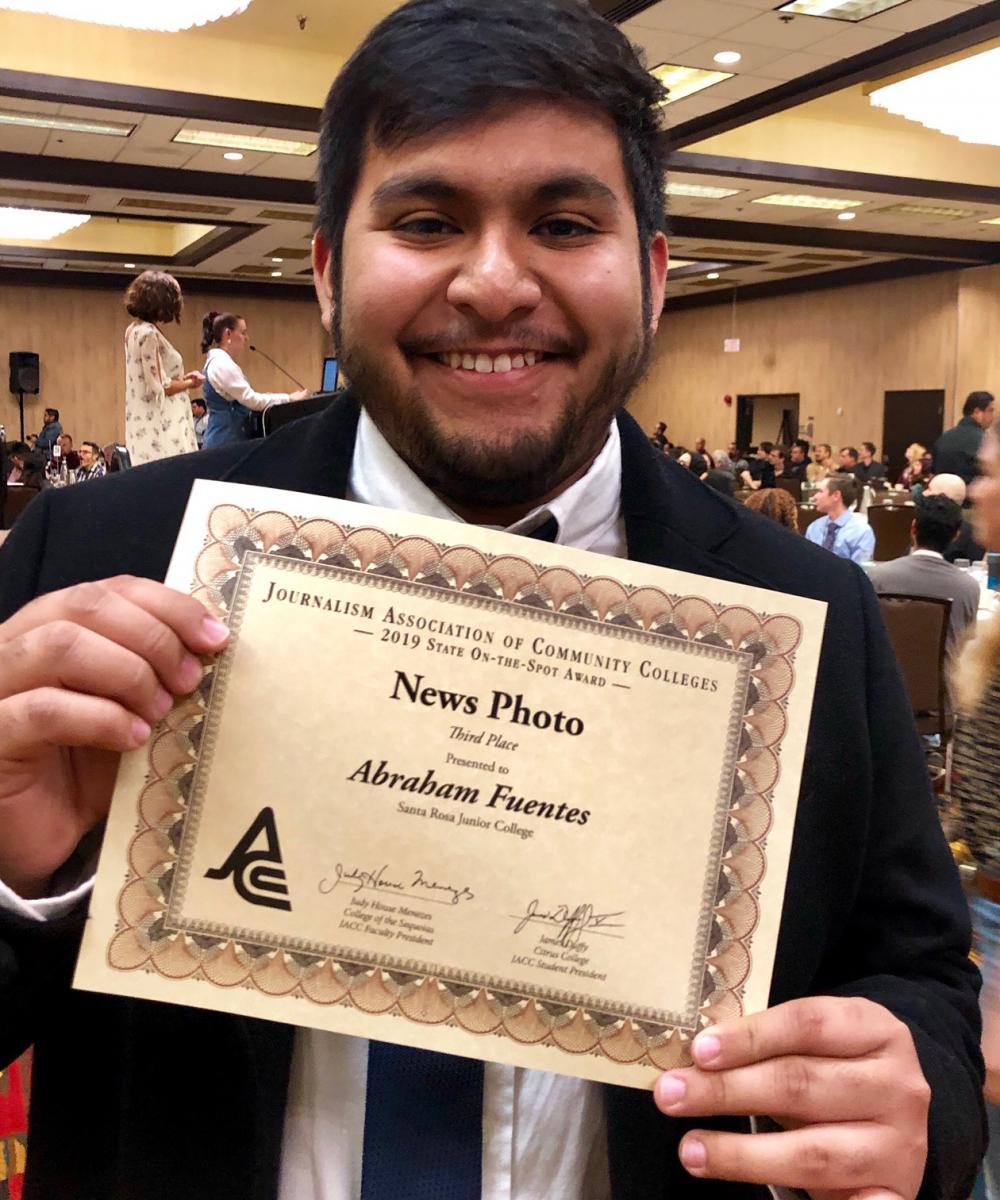 Abraham Fuentes holding his individual award.