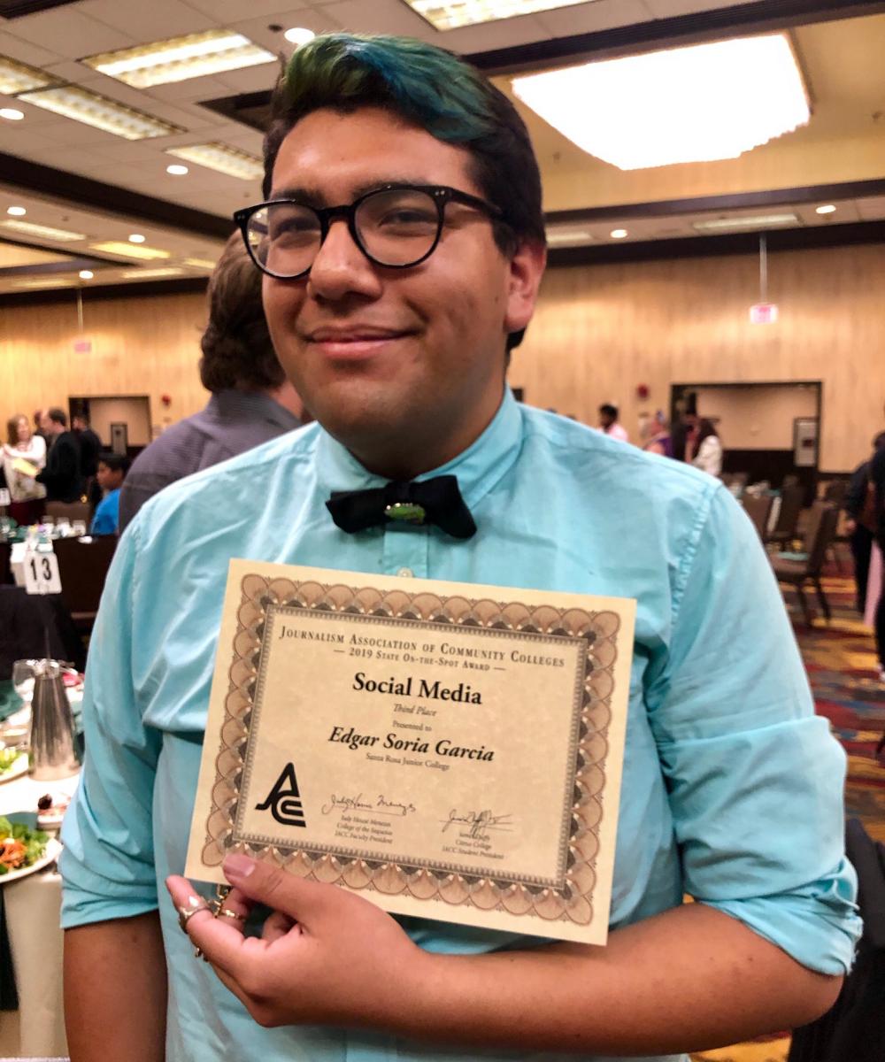 Edgar Soria Garcia holding his individual award.