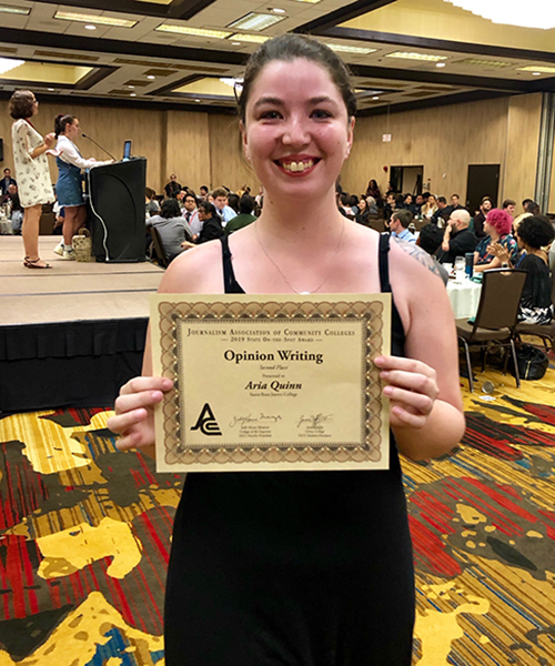 Aria Quinn holding her individual award.